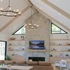 Vaulted Great Room with White Oak Shelving and Fireplace Mantel"
